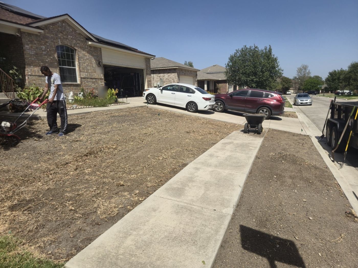 Old lawn removed and soil being tilled before sod installation